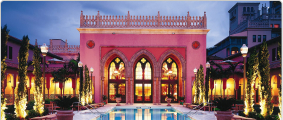 A pink hotel with a pool